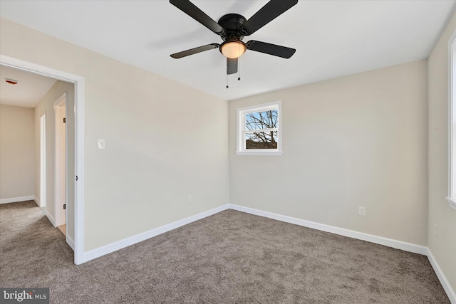 empty room featuring carpet flooring and ceiling fan