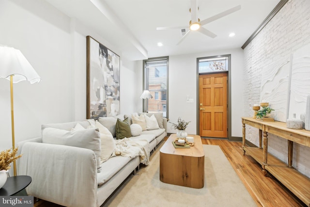 living room featuring light hardwood / wood-style floors and ceiling fan