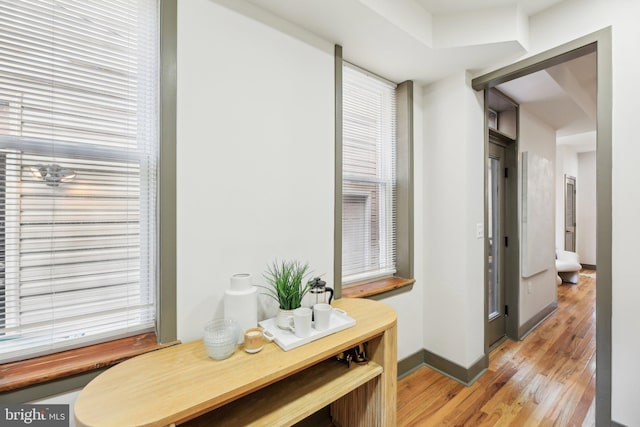 corridor with light hardwood / wood-style floors