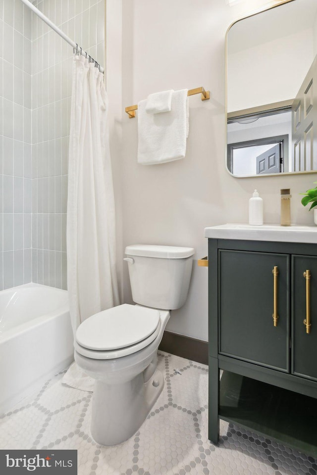 full bathroom featuring vanity, tile patterned floors, toilet, and shower / tub combo with curtain