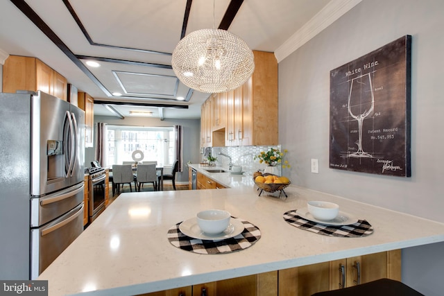 kitchen with an inviting chandelier, hanging light fixtures, decorative backsplash, appliances with stainless steel finishes, and kitchen peninsula