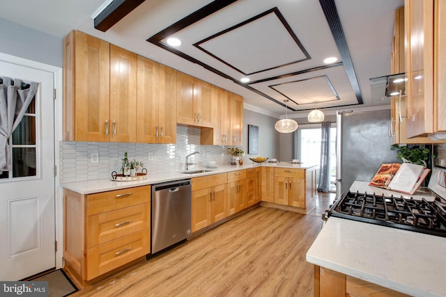 kitchen with pendant lighting, sink, light brown cabinetry, kitchen peninsula, and stainless steel appliances