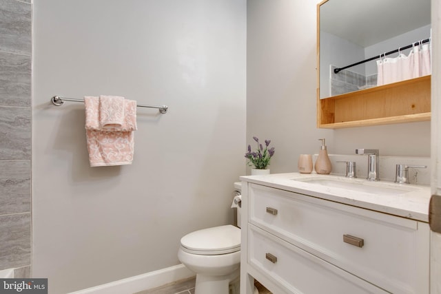 bathroom with vanity, toilet, and walk in shower