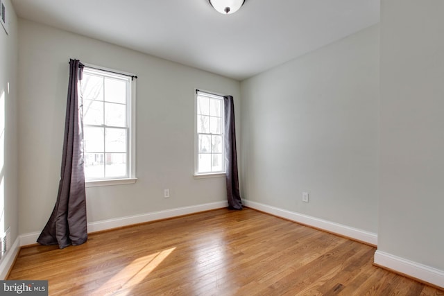 empty room with a healthy amount of sunlight and light wood-type flooring