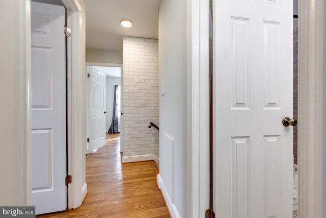 corridor with light hardwood / wood-style flooring