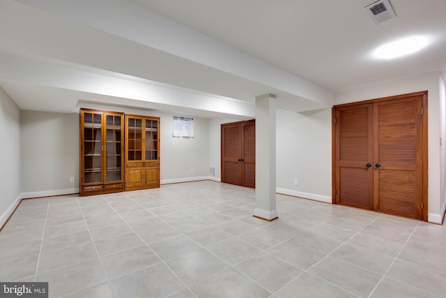 basement featuring light tile patterned flooring