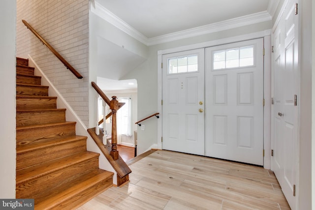 entryway featuring light wood-type flooring and crown molding