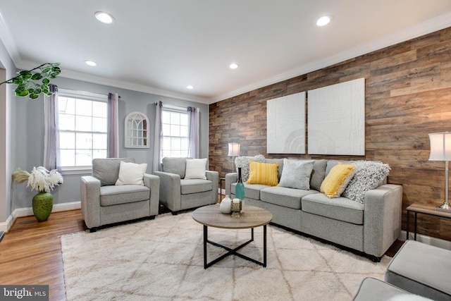 living room with plenty of natural light, light hardwood / wood-style floors, and ornamental molding