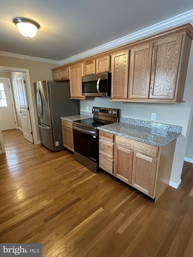 1689 Gerrardstown Rd, Gerrardstown, WV 25420 - kitchen featuring crown molding, light stone counters, dark hardwood / wood-style floors, and appliances with stainless steel finishes