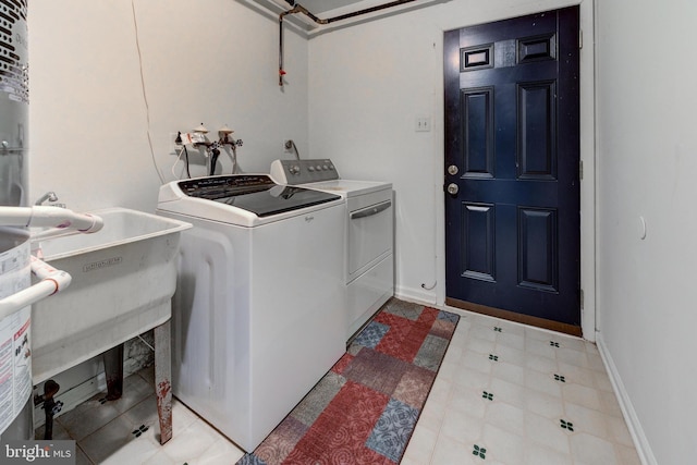 laundry area featuring washing machine and clothes dryer and sink