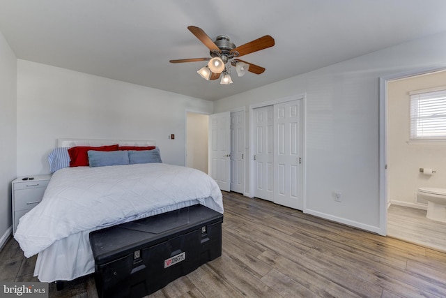 bedroom with hardwood / wood-style flooring, ceiling fan, and ensuite bathroom