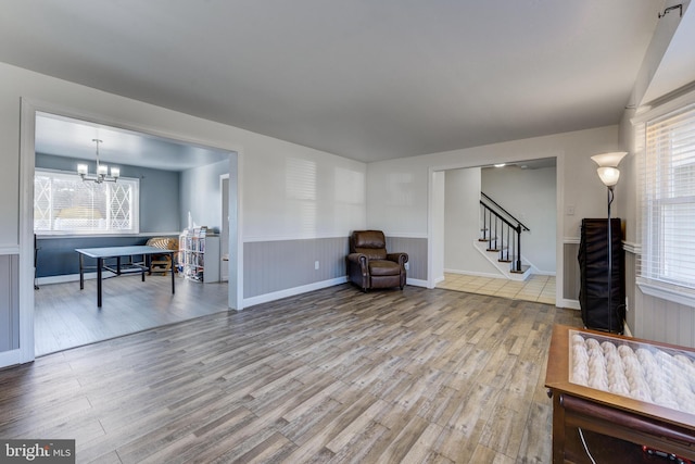 sitting room with a chandelier and light hardwood / wood-style flooring