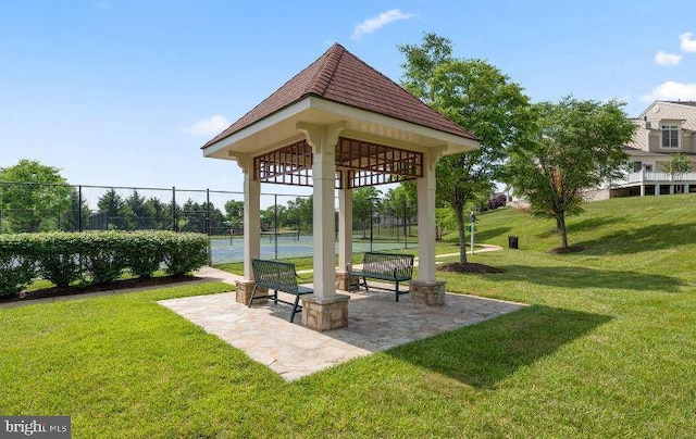 view of home's community featuring tennis court, a gazebo, and a yard