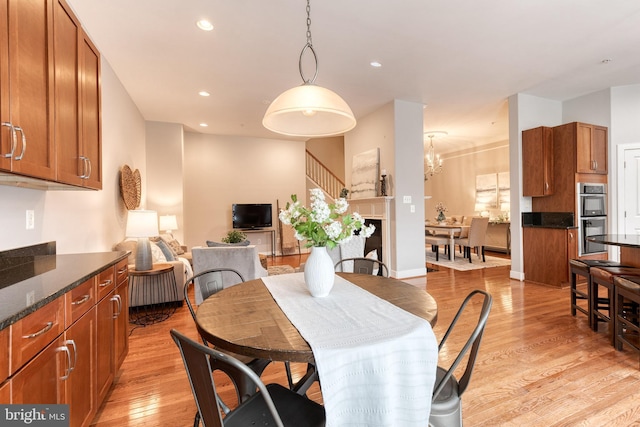 dining area featuring light hardwood / wood-style floors and a notable chandelier