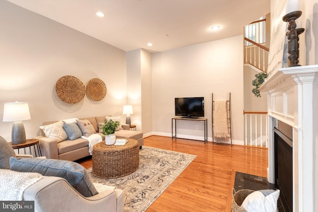 living room with hardwood / wood-style floors and a fireplace