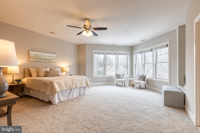 bedroom with ceiling fan and light carpet