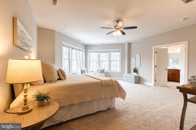 bedroom featuring ceiling fan, ensuite bathroom, and light carpet