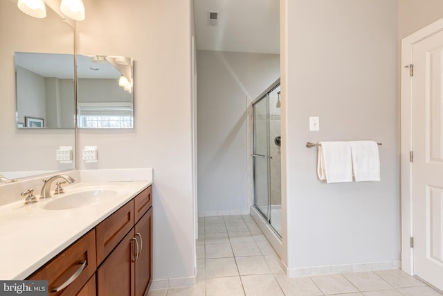 bathroom featuring vanity, a shower with door, and tile patterned floors