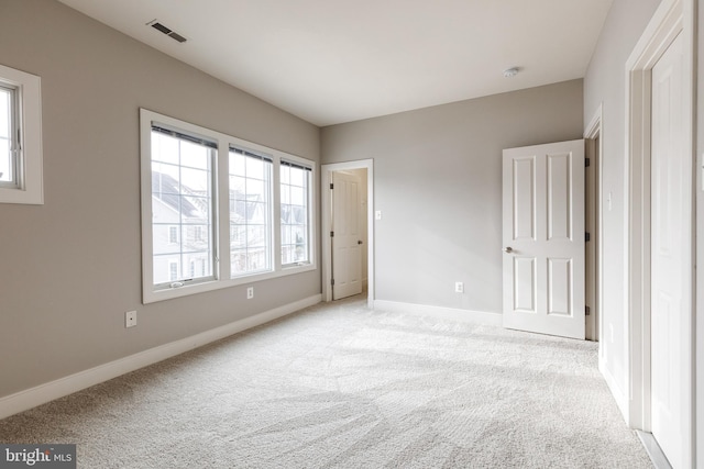 unfurnished bedroom featuring light colored carpet