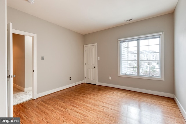 unfurnished room with light hardwood / wood-style floors