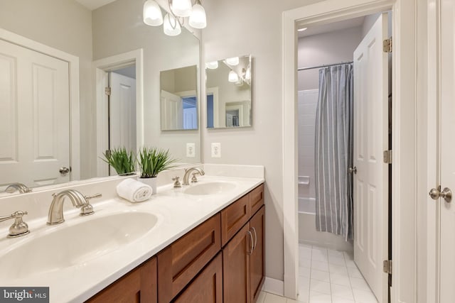 bathroom featuring shower / bathtub combination with curtain, tile patterned floors, and vanity