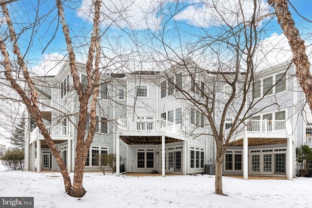 snow covered property with cooling unit