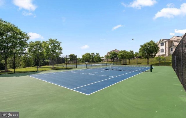 view of tennis court with basketball hoop