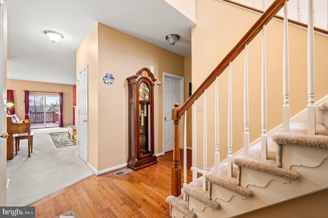 stairway with hardwood / wood-style flooring