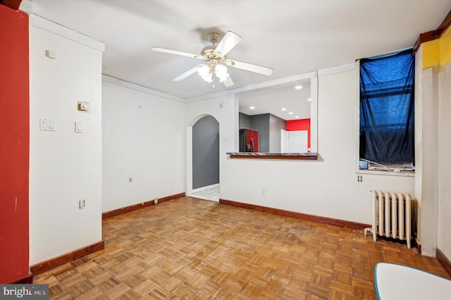 empty room with parquet flooring, radiator heating unit, and ceiling fan