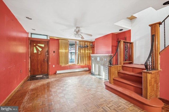 foyer featuring baseboard heating, ceiling fan, and parquet floors