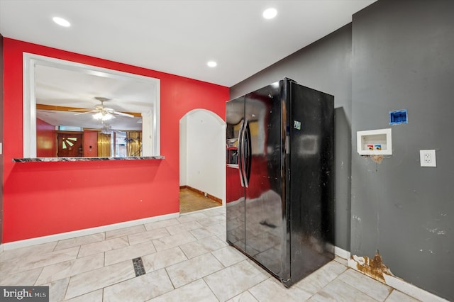 kitchen featuring black fridge, ceiling fan, and light tile patterned floors