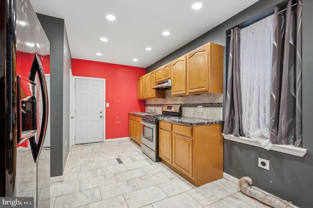 kitchen featuring stainless steel appliances and backsplash