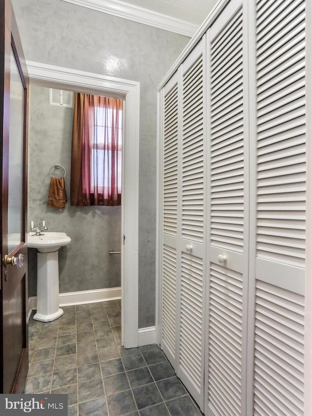 bathroom with sink and crown molding