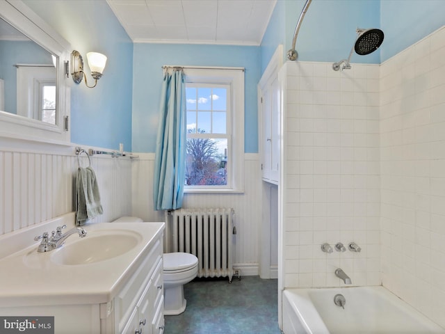 full bathroom featuring radiator heating unit, vanity, tiled shower / bath combo, and toilet