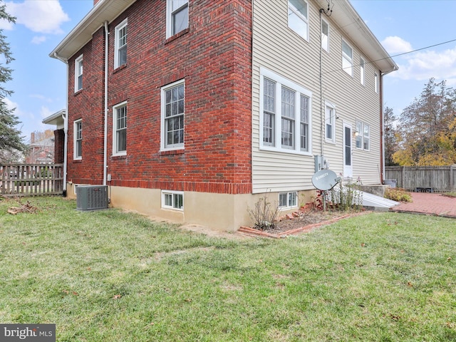 view of property exterior featuring a yard and central AC