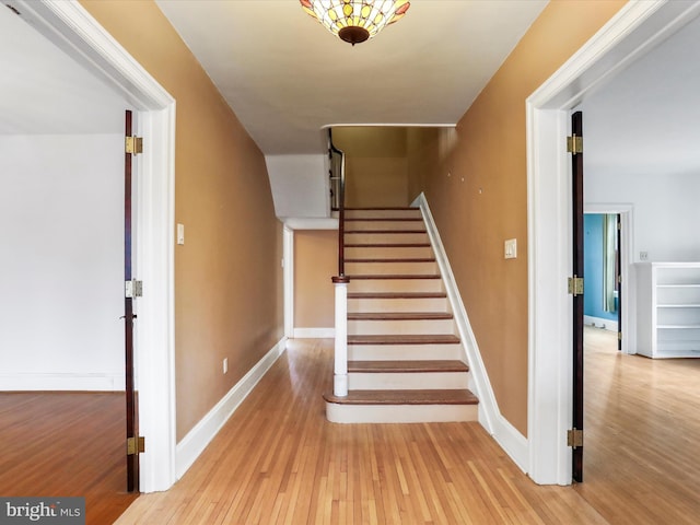 staircase featuring hardwood / wood-style flooring