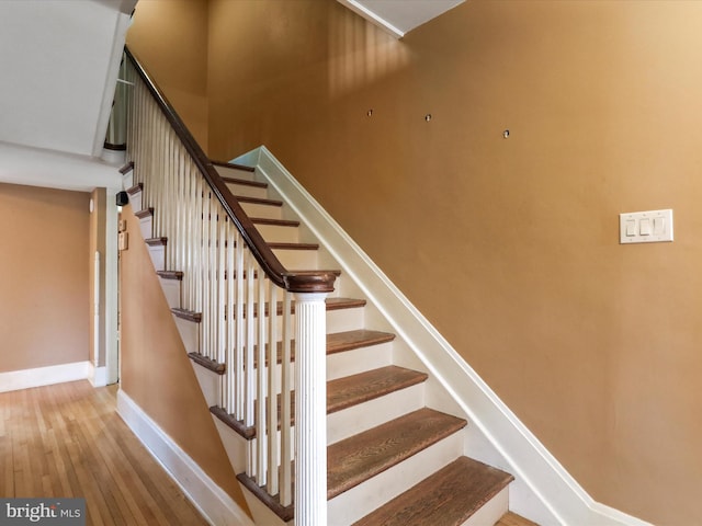 stairs featuring hardwood / wood-style floors