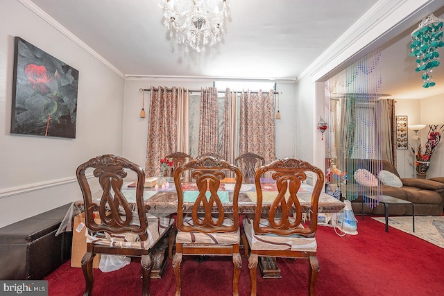 dining area with a notable chandelier, ornamental molding, and carpet floors