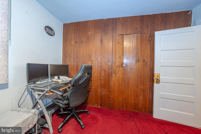 carpeted office with wood walls