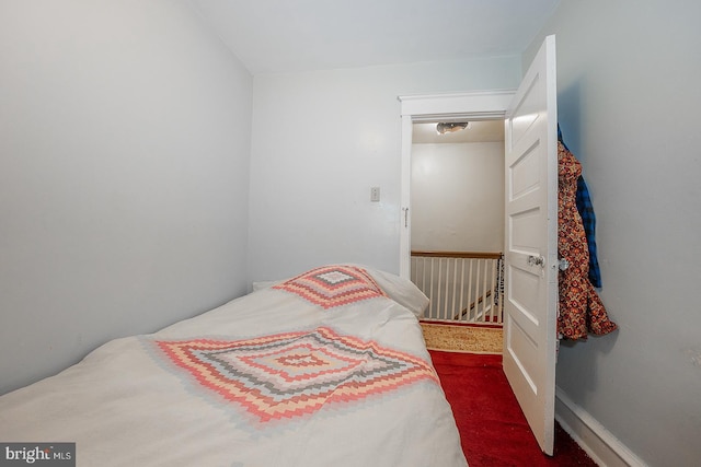 bedroom with dark colored carpet