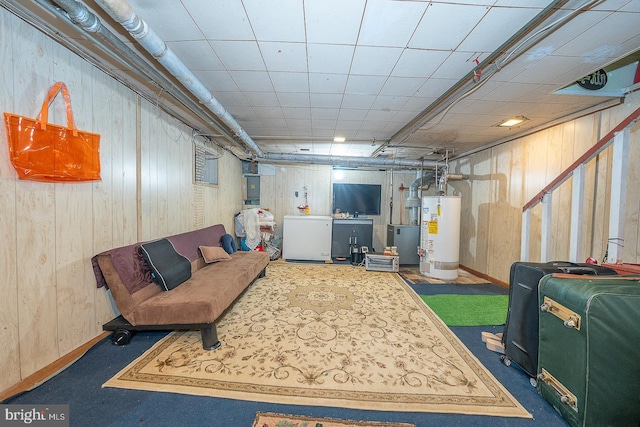 basement with wooden walls, refrigerator, dark carpet, and gas water heater