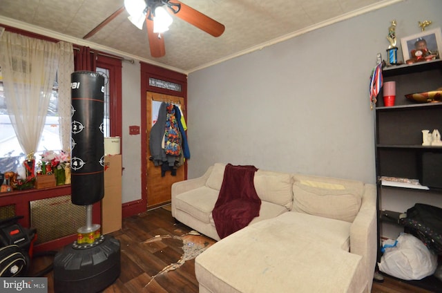 sitting room featuring dark hardwood / wood-style floors, ceiling fan, and ornamental molding