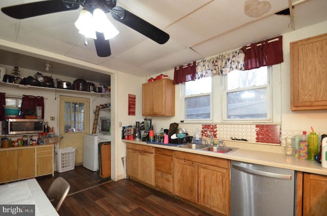 kitchen with stainless steel appliances, ceiling fan, sink, washer / clothes dryer, and dark hardwood / wood-style floors