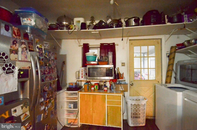 kitchen featuring washing machine and dryer and appliances with stainless steel finishes