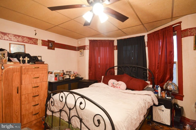 bedroom featuring a paneled ceiling and ceiling fan