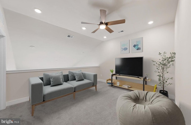 living room with ceiling fan, light carpet, and lofted ceiling