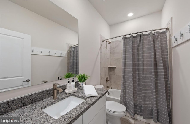 full bathroom with toilet, shower / bathtub combination with curtain, and vanity