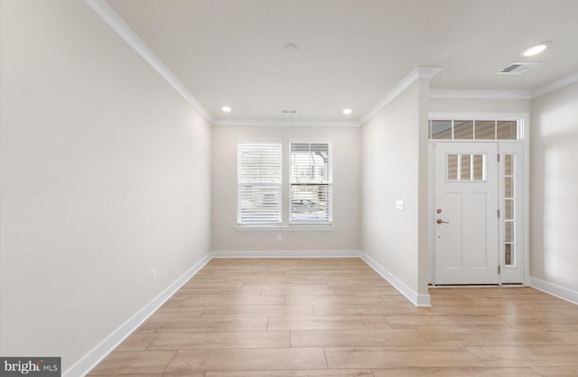 foyer featuring light wood-type flooring and crown molding