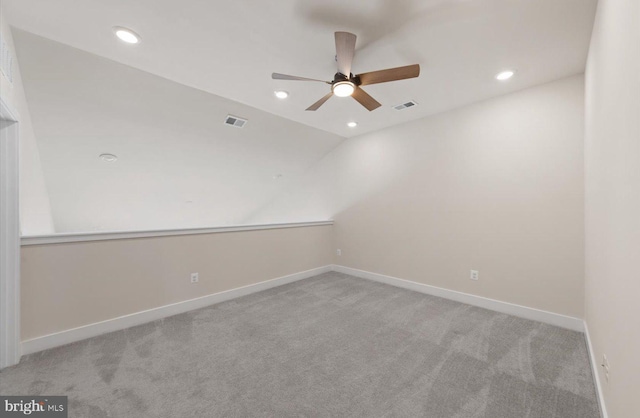 unfurnished room featuring lofted ceiling, light colored carpet, and ceiling fan