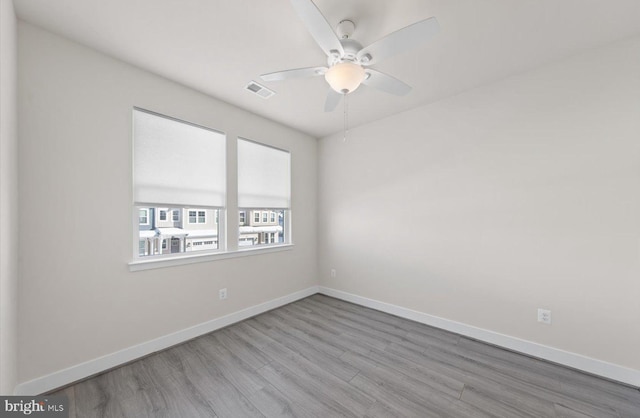 unfurnished room with ceiling fan and light hardwood / wood-style floors